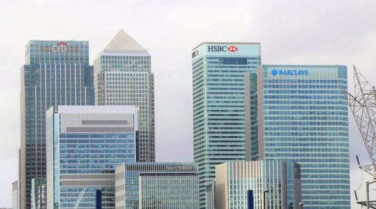 UK Savings Accounts. A photo of Canary Wharf from a distance, showing the top of the some of the biggest banks offices.